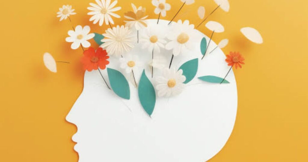  A person writing in a journal during a calm morning, symbolizing a daily gratitude practice for mental health.